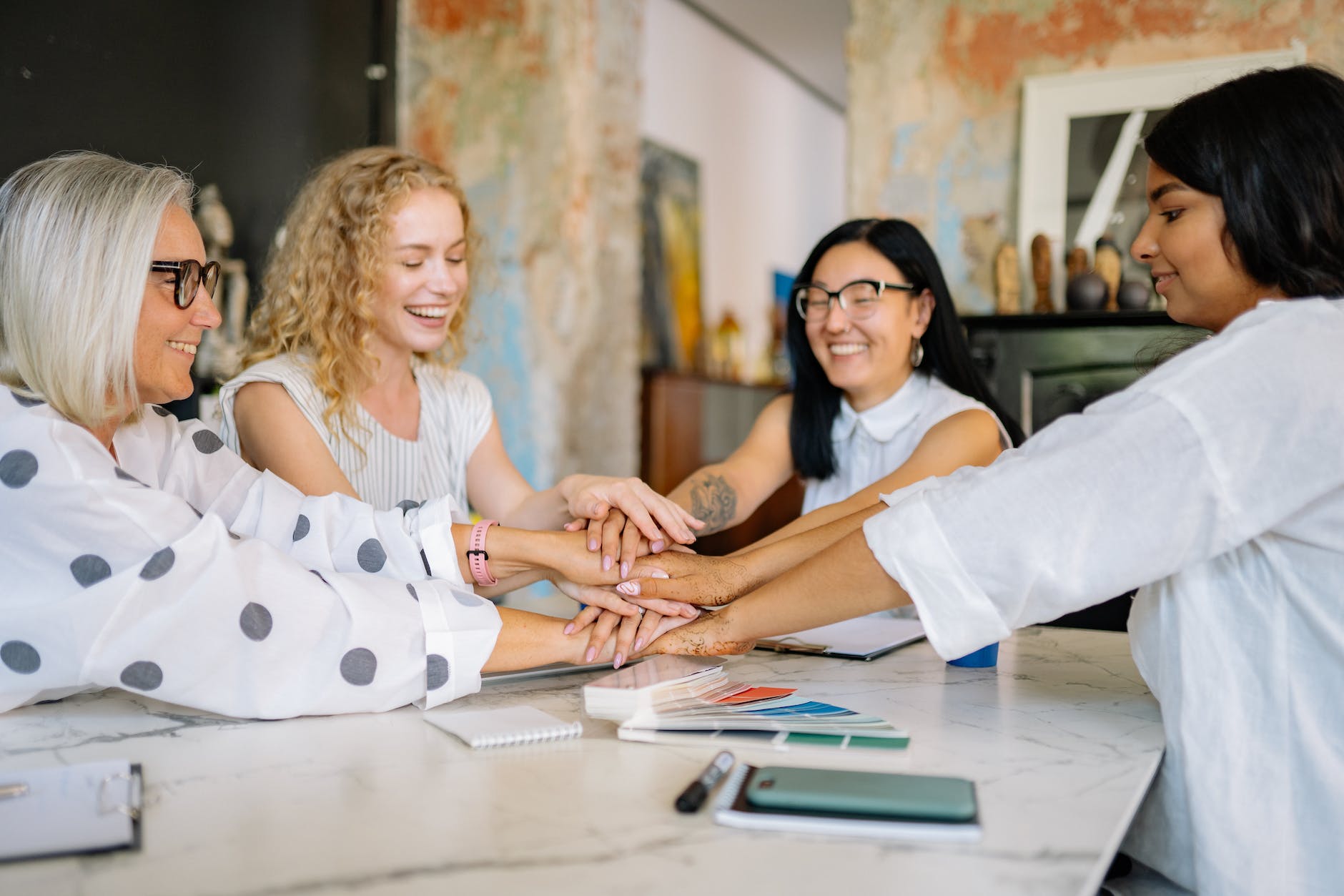 women putting their hands together