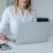 woman using silver laptop